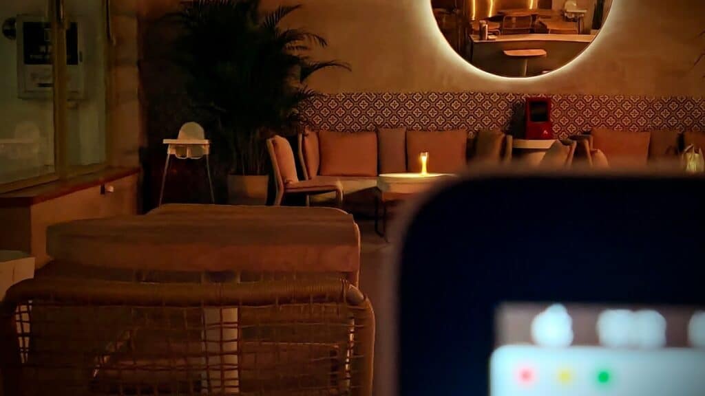 Warmly lit hotel lounge with cosy seating and ambient lighting, representing the atmosphere that builds guest trust and drives direct bookings
