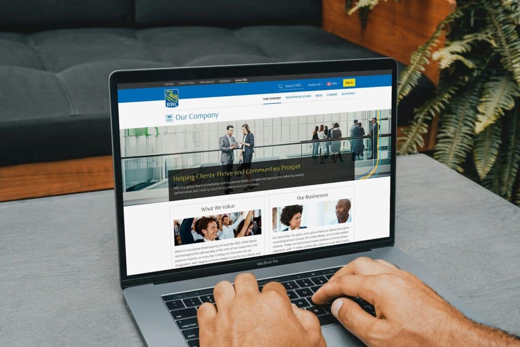 Person browsing a hotel website on a laptop, highlighting the importance of above-the-fold design elements for converting visitors into direct bookings